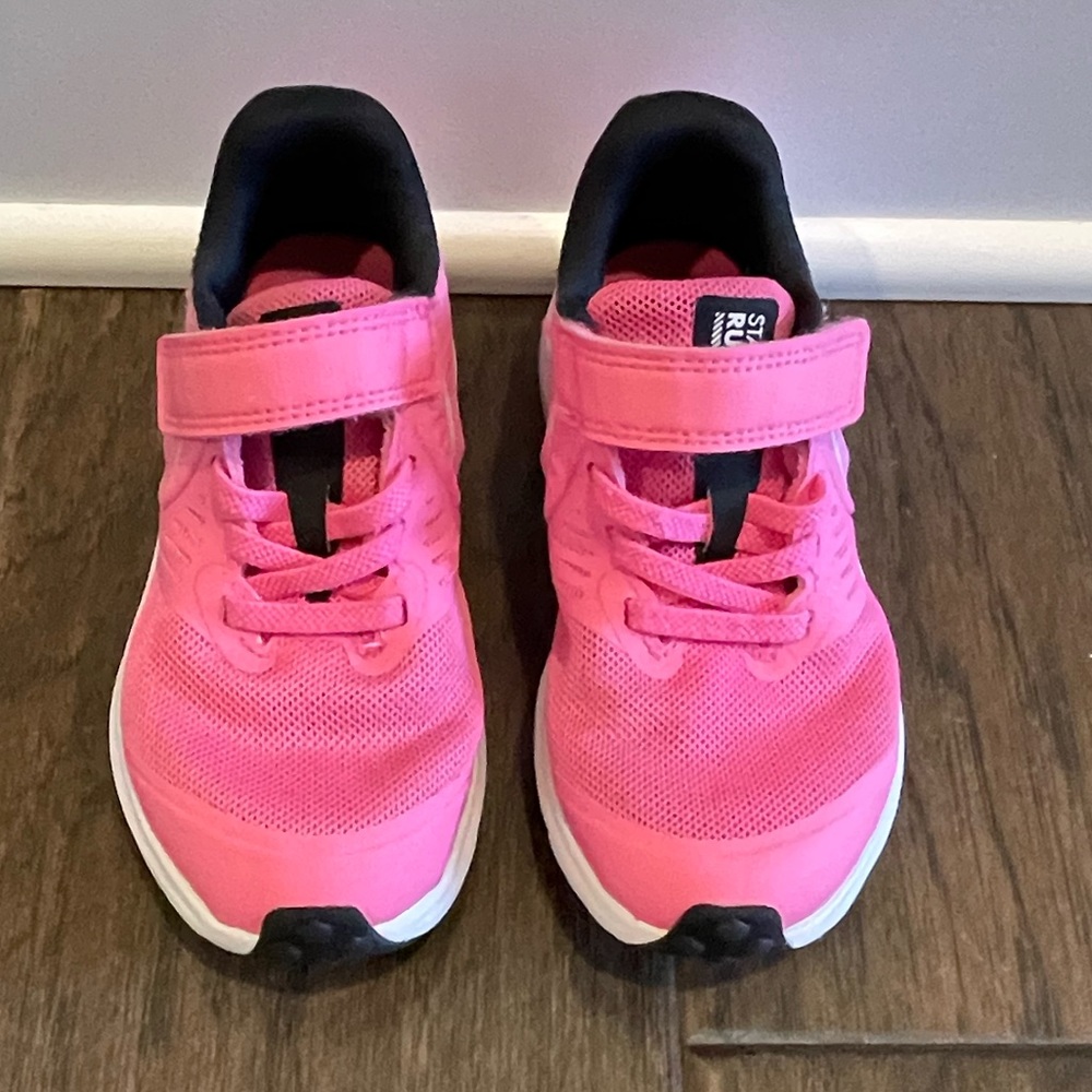 Girls bright pink Nike tennis shoes